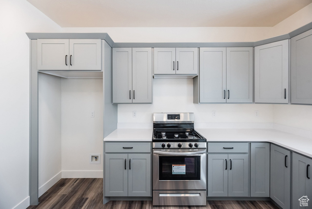 Kitchen featuring dark wood-type flooring, stainless steel gas range, and gray cabinetry