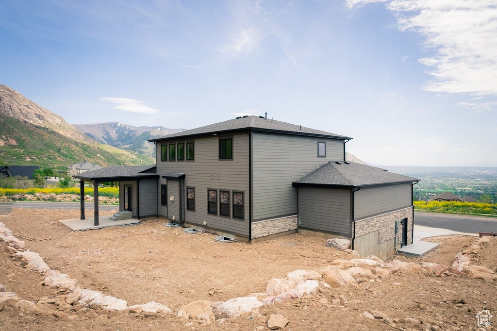 Rear view of property featuring a mountain view