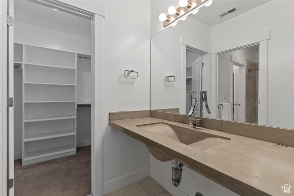 Bathroom with a shower and tile patterned flooring