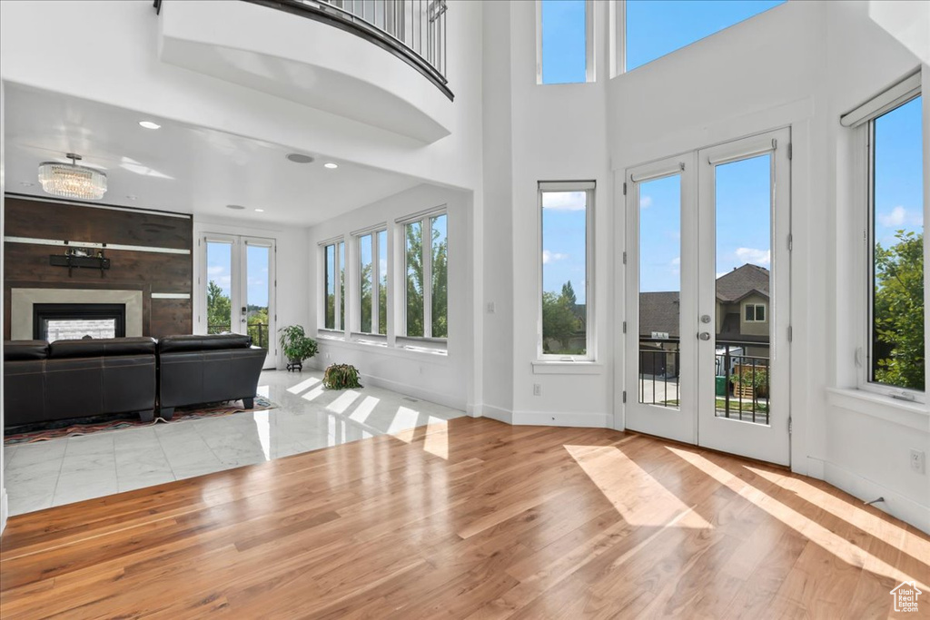 Unfurnished living room with light hardwood / wood-style floors and french doors