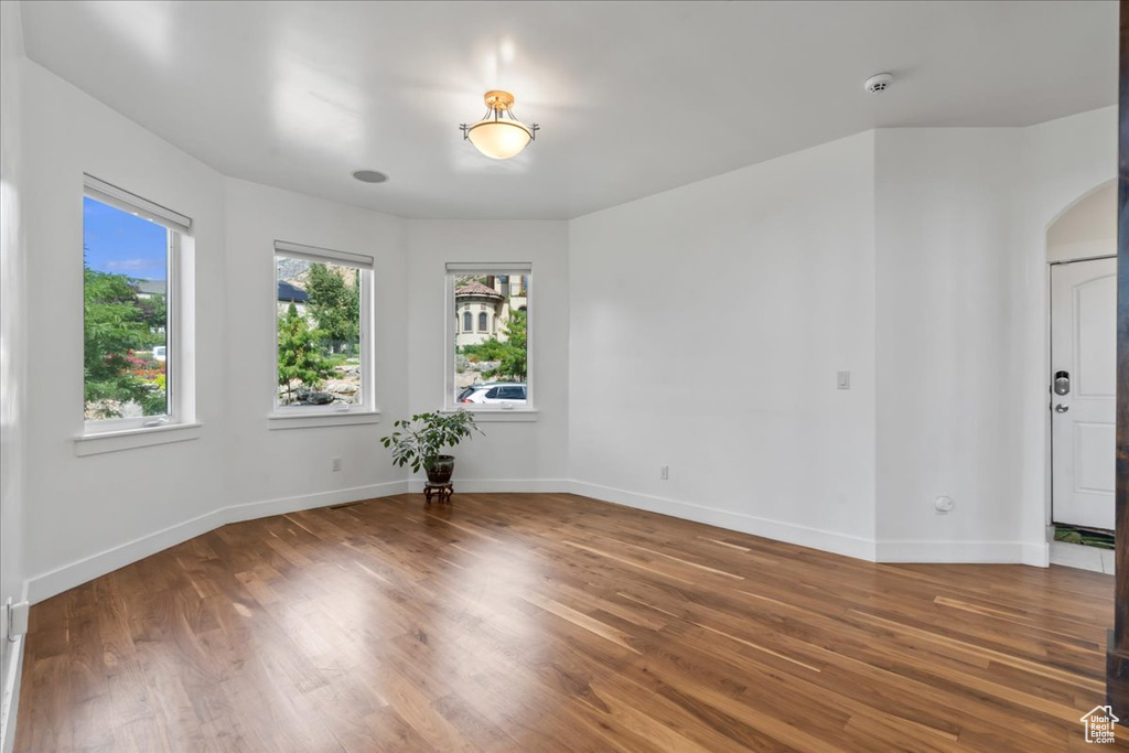 Empty room featuring dark hardwood / wood-style floors