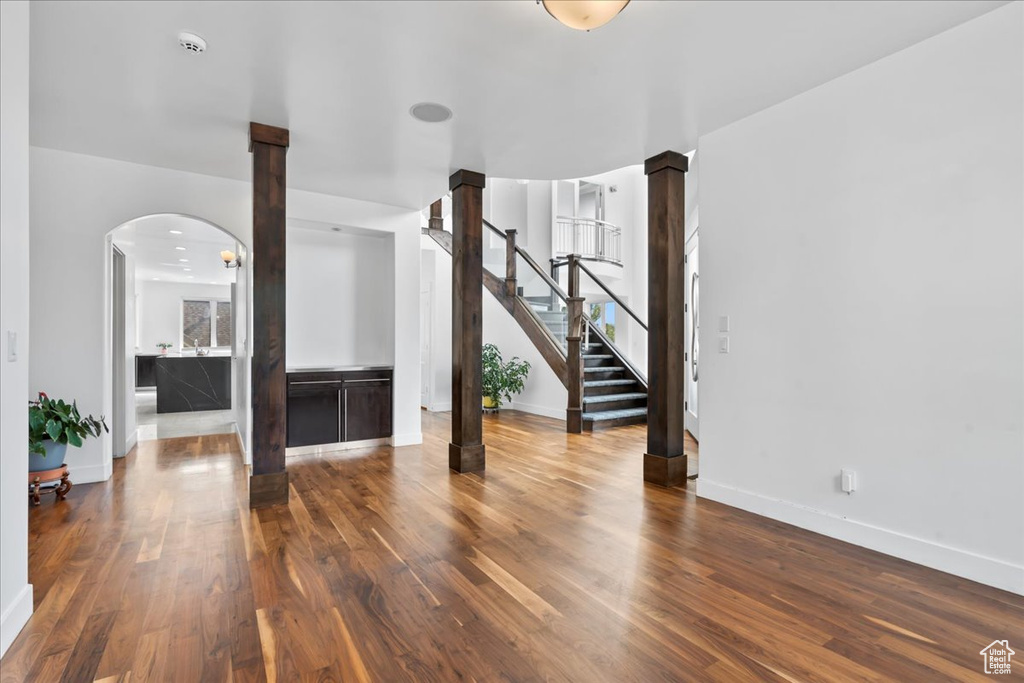 Interior space with dark wood-type flooring and ornate columns