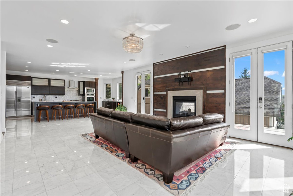 Living room featuring french doors and a multi sided fireplace