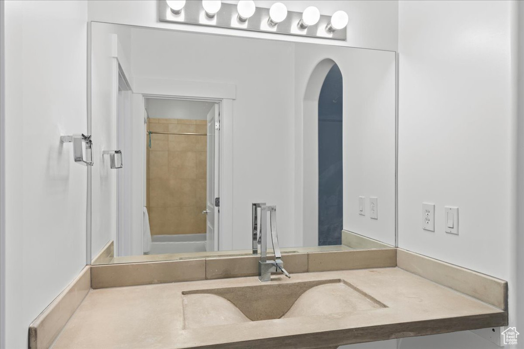 Bathroom featuring vanity and tiled shower / bath combo