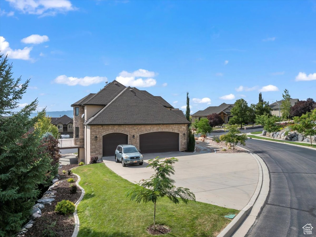 Exterior space featuring a garage and a lawn