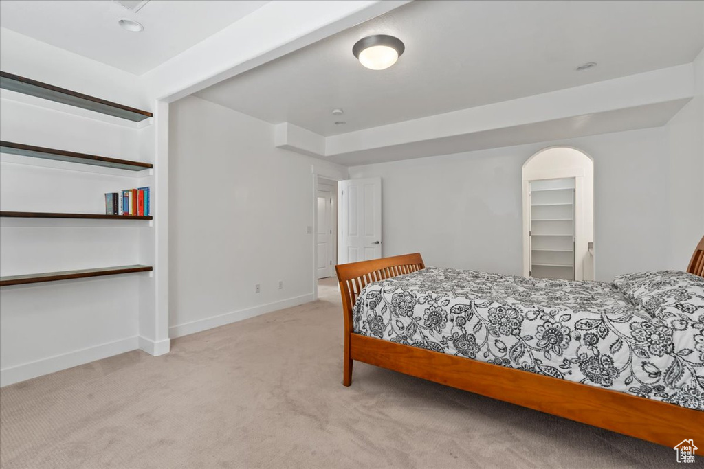 Bedroom featuring light colored carpet