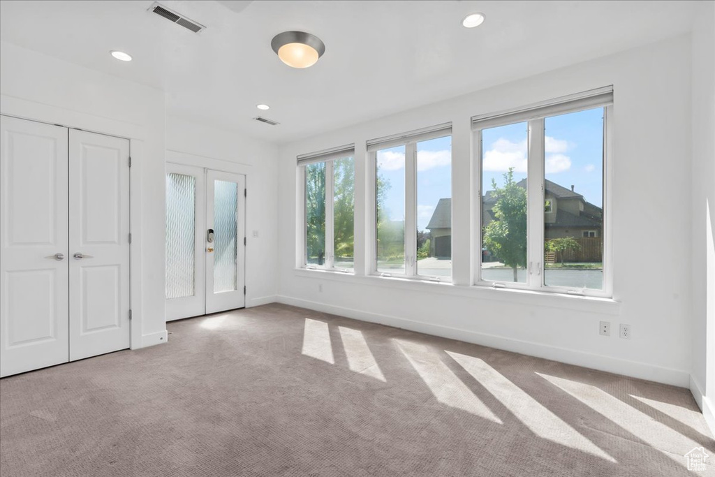 Unfurnished bedroom with light carpet