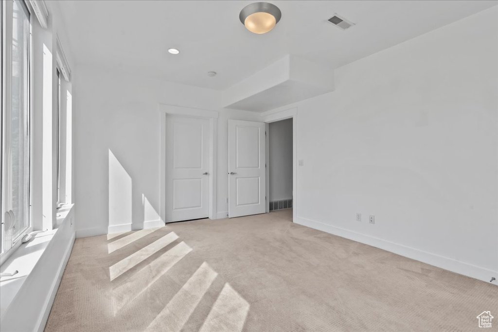 Unfurnished room with light colored carpet