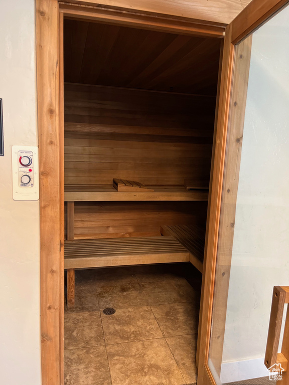 View of sauna featuring wooden ceiling and tile patterned floors