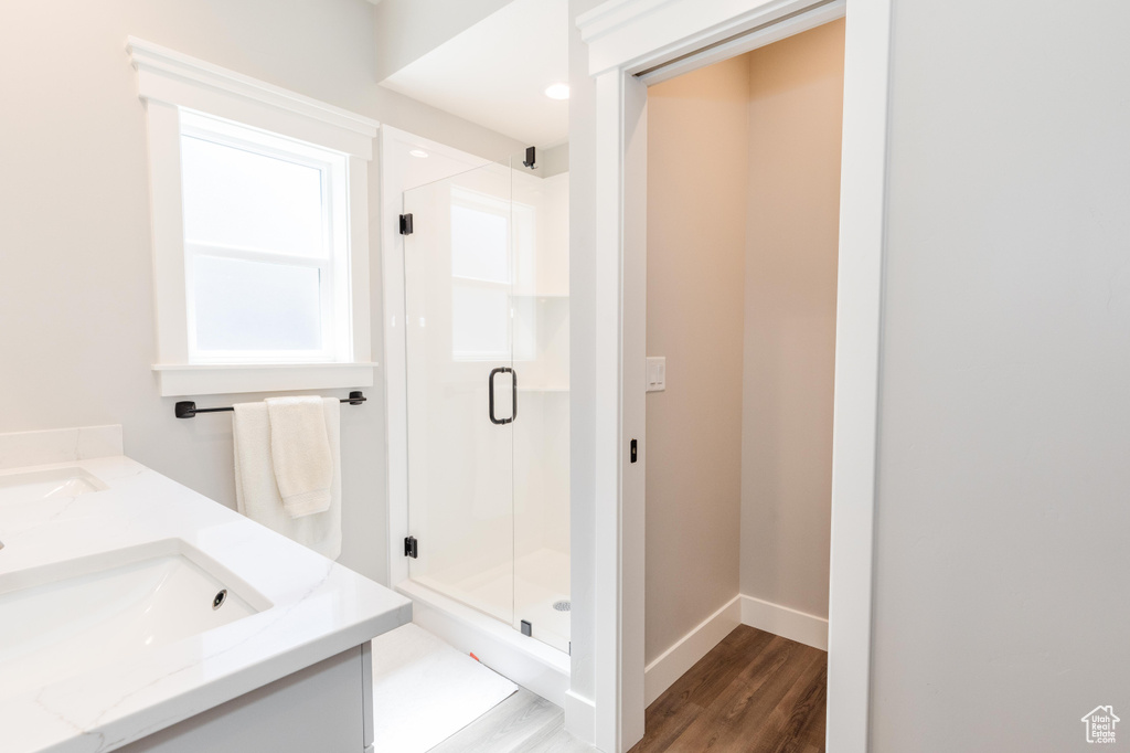 Bathroom featuring vanity, an enclosed shower, and hardwood / wood-style flooring