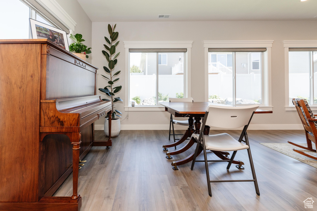 Dining area featuring a wealth of natural light and dark hardwood / wood-style floors