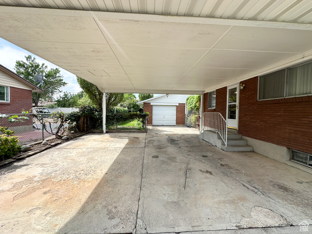 View of patio with an outbuilding and a garage