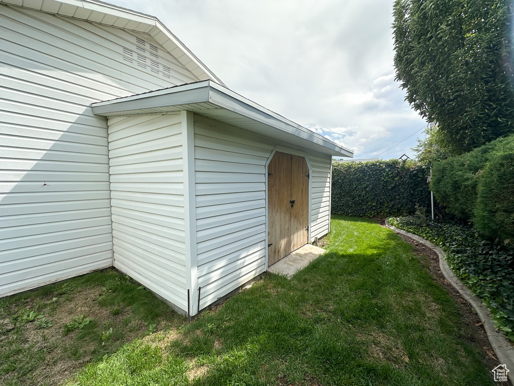 View of property exterior with a lawn