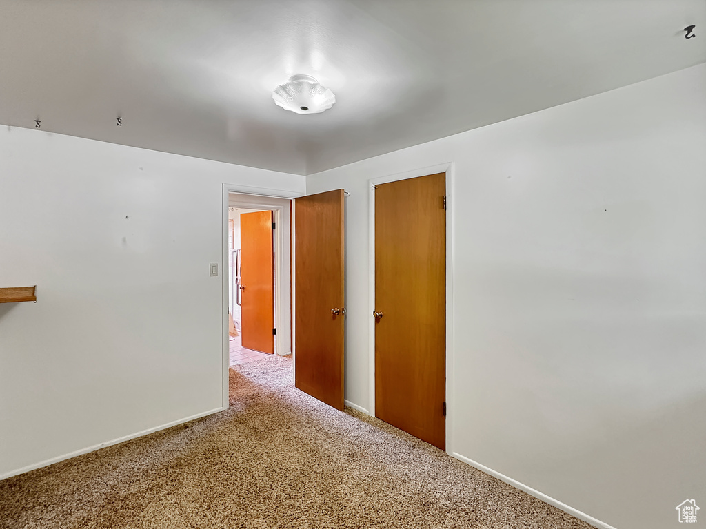 Unfurnished bedroom with carpet flooring