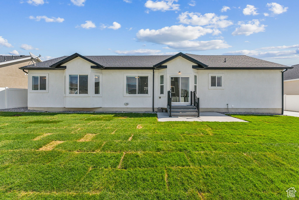 Back of property featuring a yard