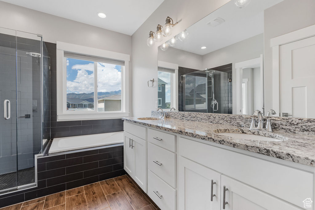 Bathroom featuring vanity, hardwood / wood-style floors, and independent shower and bath