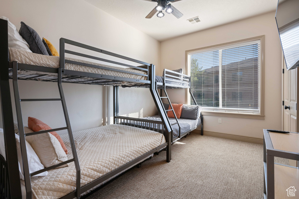 Carpeted bedroom with ceiling fan