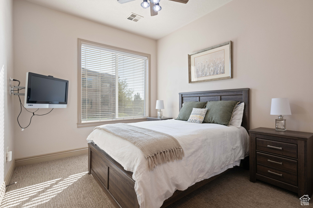 Carpeted bedroom with ceiling fan