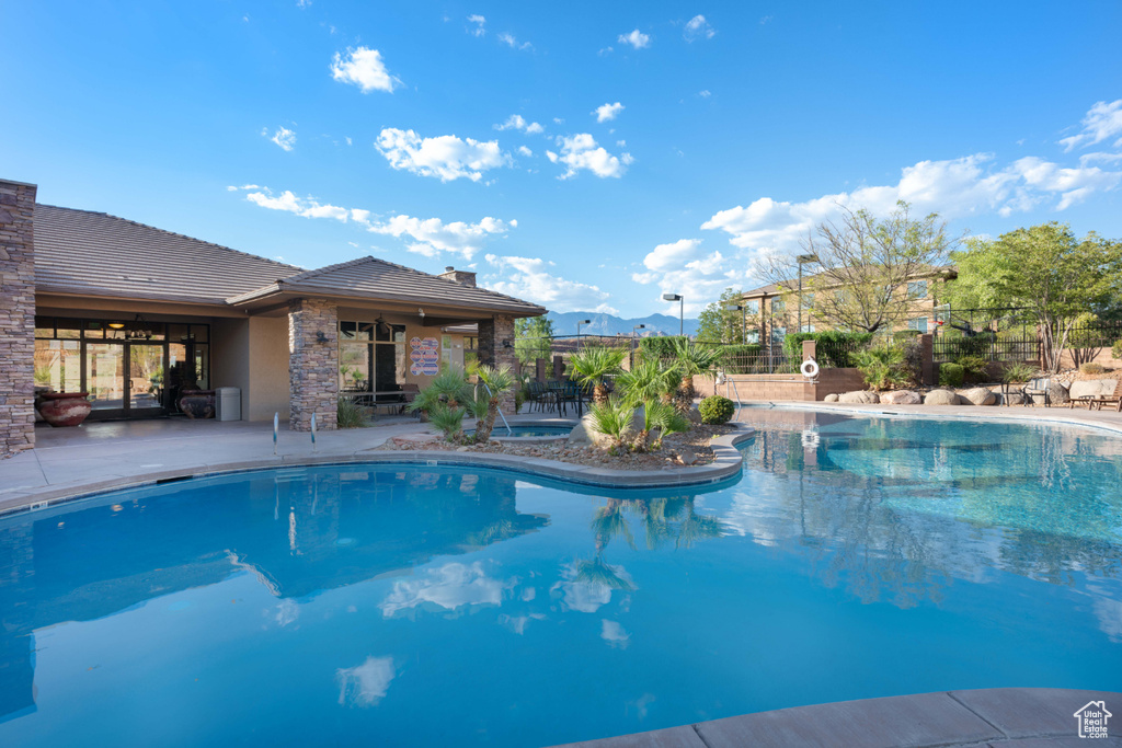 View of swimming pool with a patio area and a mountain view