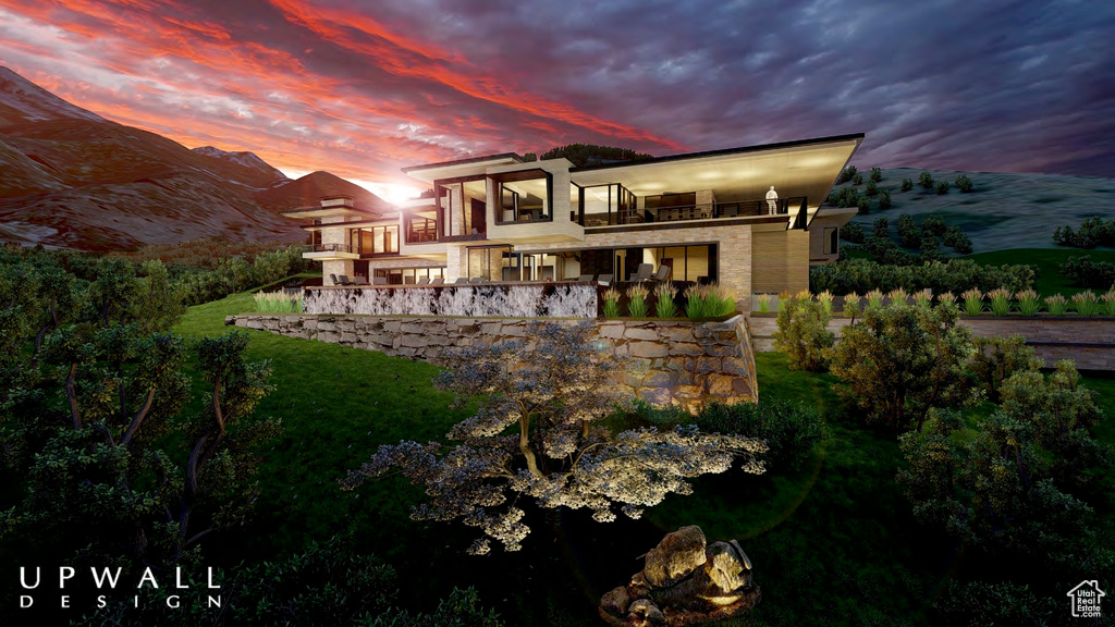 Back house at dusk with a balcony and a mountain view