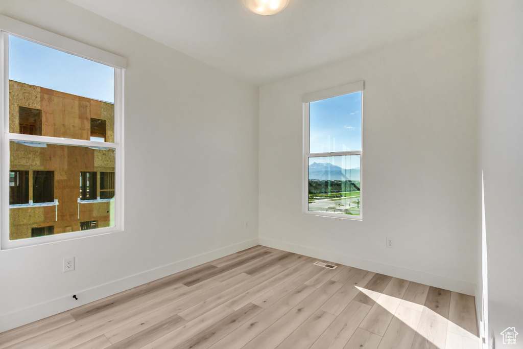 Spare room featuring light wood-type flooring