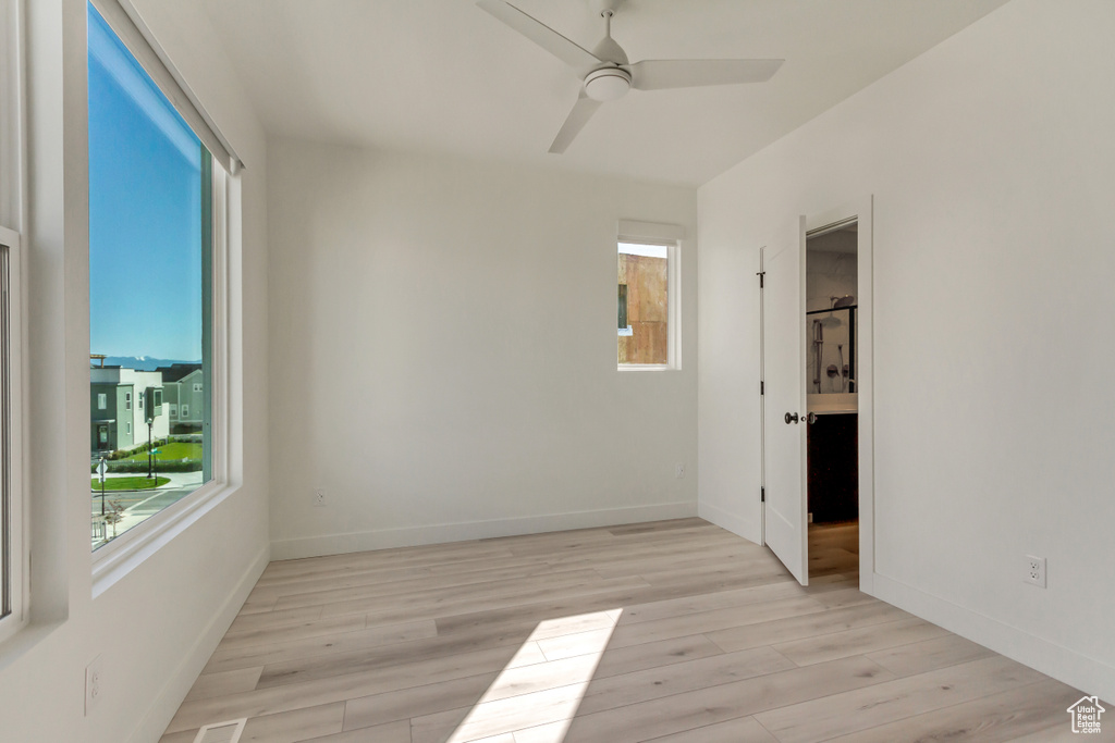 Unfurnished room featuring ceiling fan and light hardwood / wood-style floors