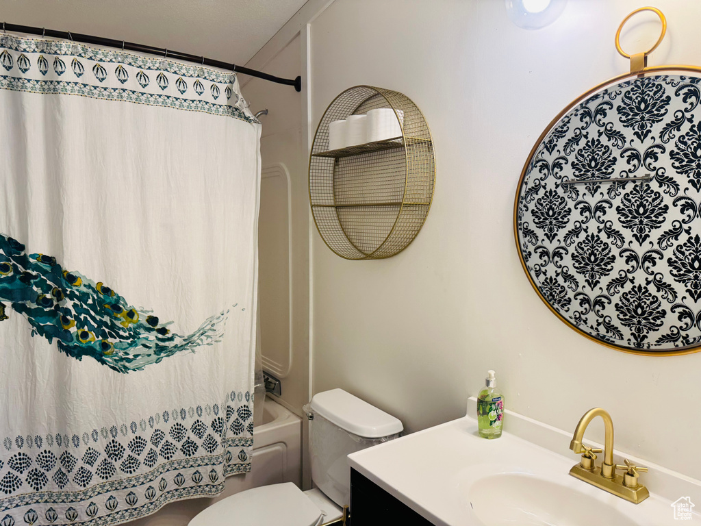 Full bath with vanity, toilet, and shower / bathtub combination with curtain