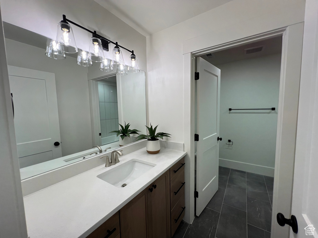 Bathroom with tile patterned floors, visible vents, and vanity