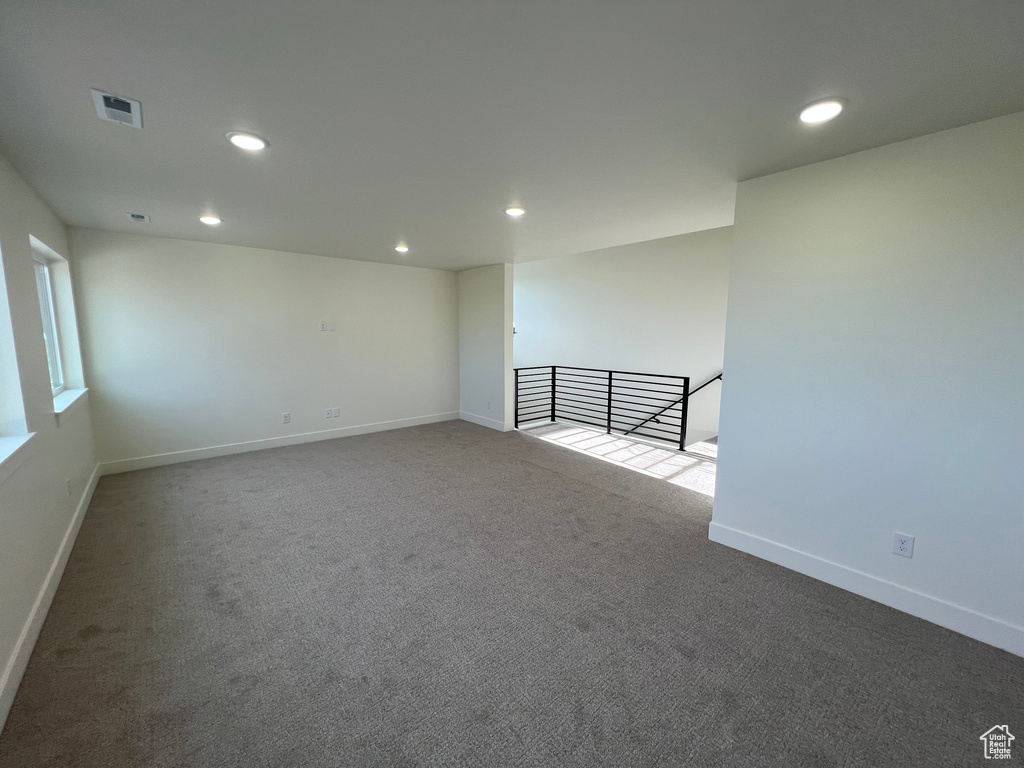 Carpeted empty room with recessed lighting, baseboards, and visible vents