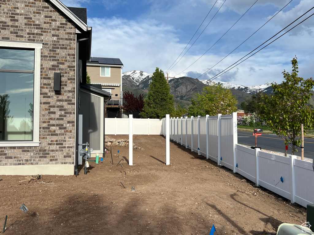 View of yard with a fenced backyard and a mountain view