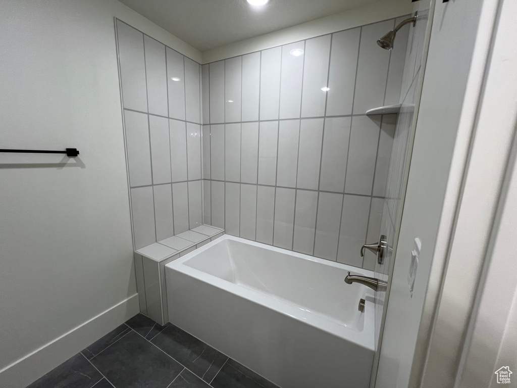 Bathroom featuring baseboards, tile patterned floors, and shower / bathing tub combination