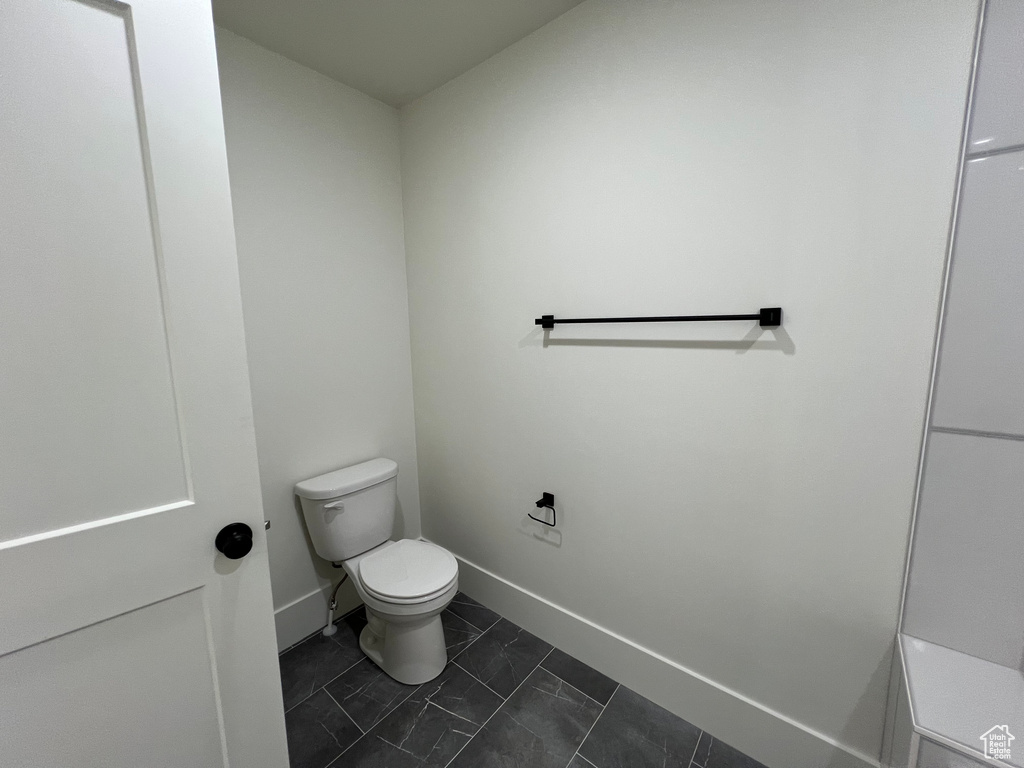 Bathroom with toilet and baseboards