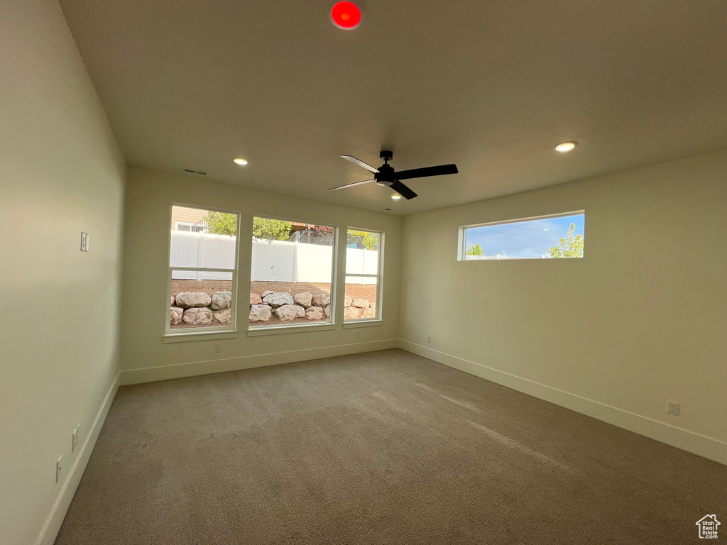 Spare room featuring recessed lighting, baseboards, and carpet