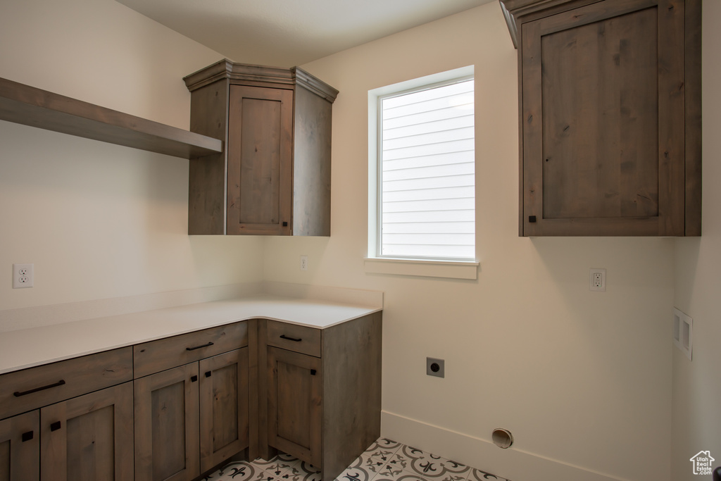 Laundry room with cabinets and electric dryer hookup