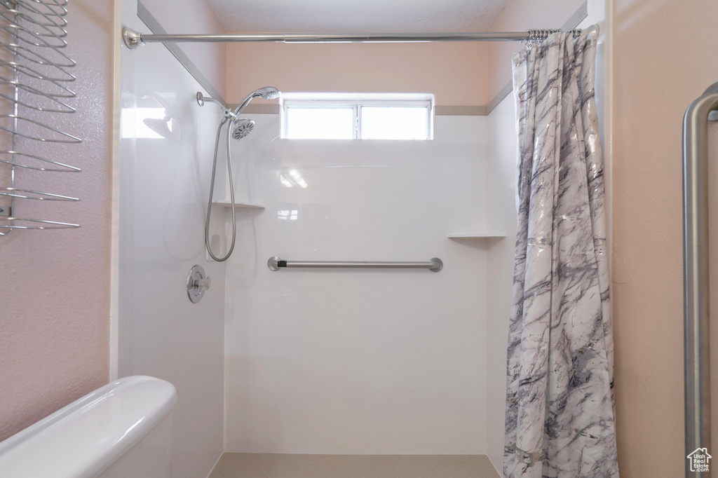 Bathroom with toilet and walk in shower