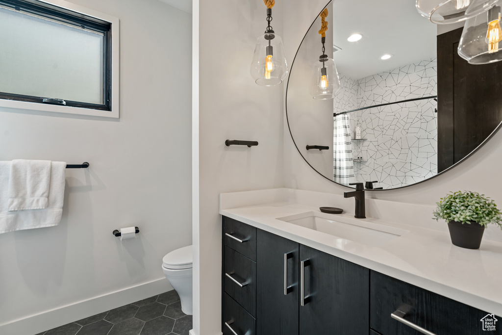 Bathroom featuring vanity, toilet, and tile patterned floors