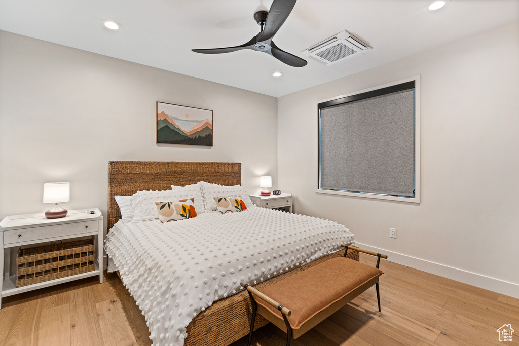 Bedroom with light hardwood / wood-style flooring and ceiling fan