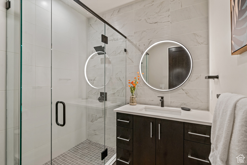 Bathroom with a shower with door and vanity