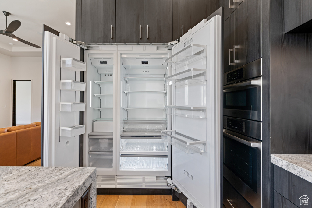 Walk in closet featuring ceiling fan and light wood-type flooring