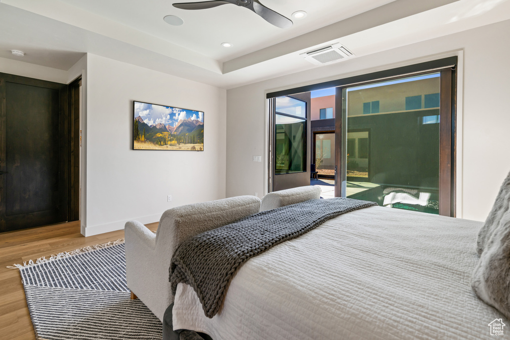 Bedroom with access to exterior, ceiling fan, and light hardwood / wood-style flooring