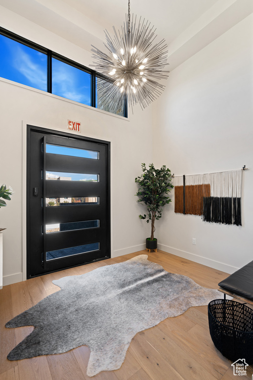 Entrance foyer featuring a chandelier and hardwood / wood-style flooring