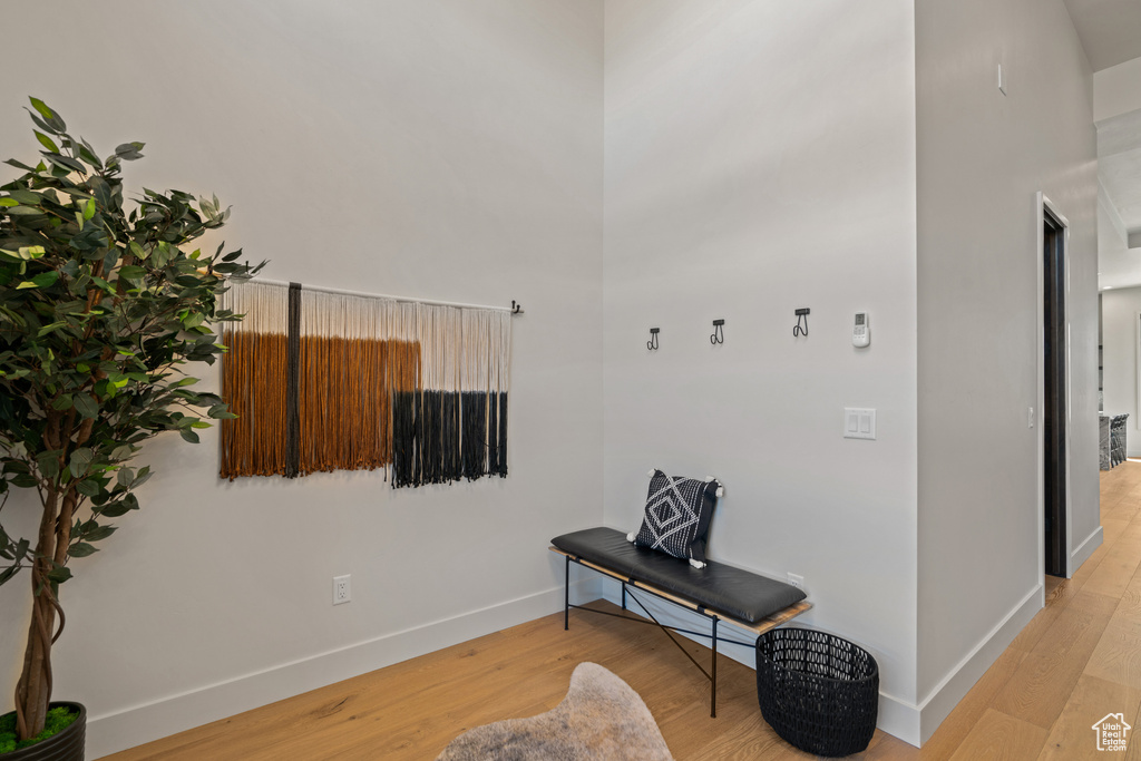 Living area featuring a high ceiling and light hardwood / wood-style flooring