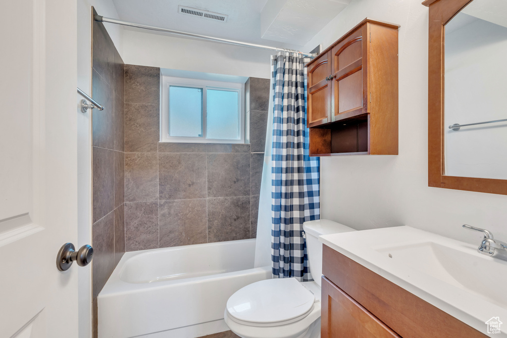 Full bathroom with vanity, toilet, and shower / tub combo