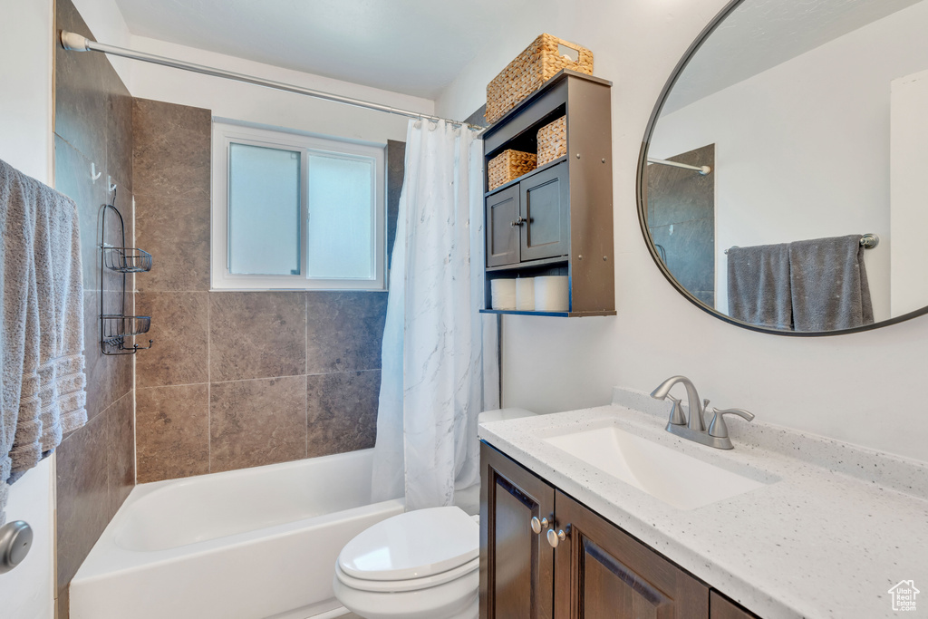 Full bathroom with vanity, toilet, and shower / bath combo