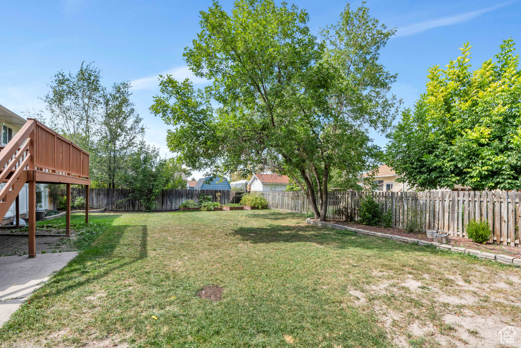 View of yard with a wooden deck