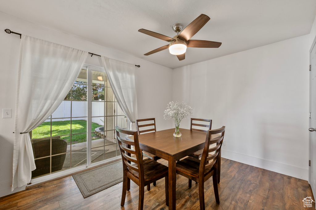 Dining space featuring ceiling fan and dark hardwood / wood-style flooring