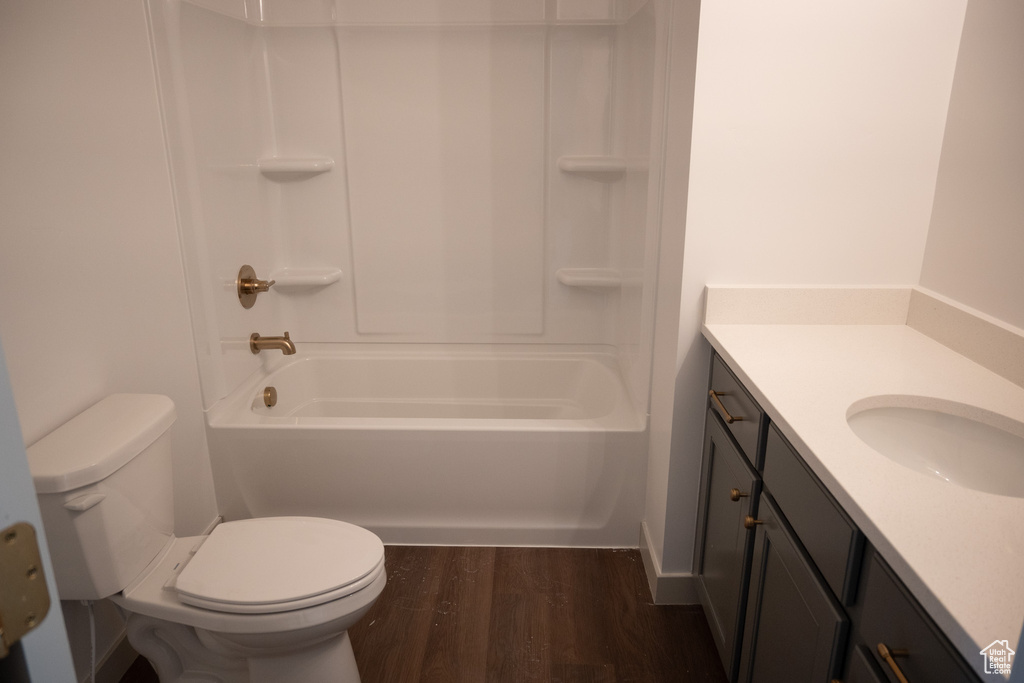 Full bathroom featuring vanity, hardwood / wood-style floors, toilet, and tub / shower combination