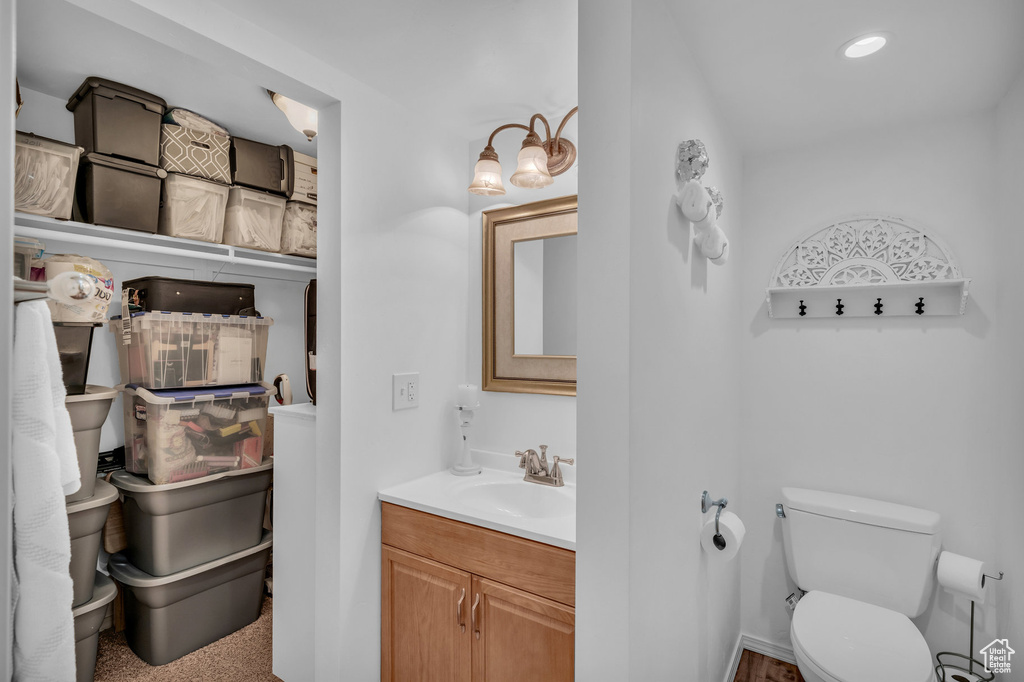 Bathroom featuring toilet, recessed lighting, and vanity