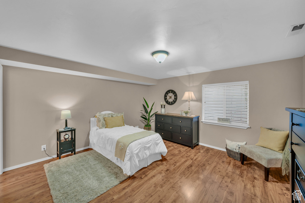 Bedroom featuring light wood-type flooring, visible vents, and baseboards