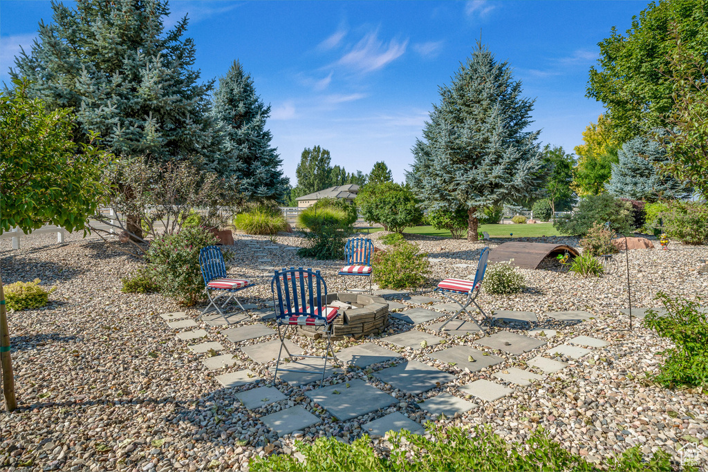 View of yard with a fire pit and a patio